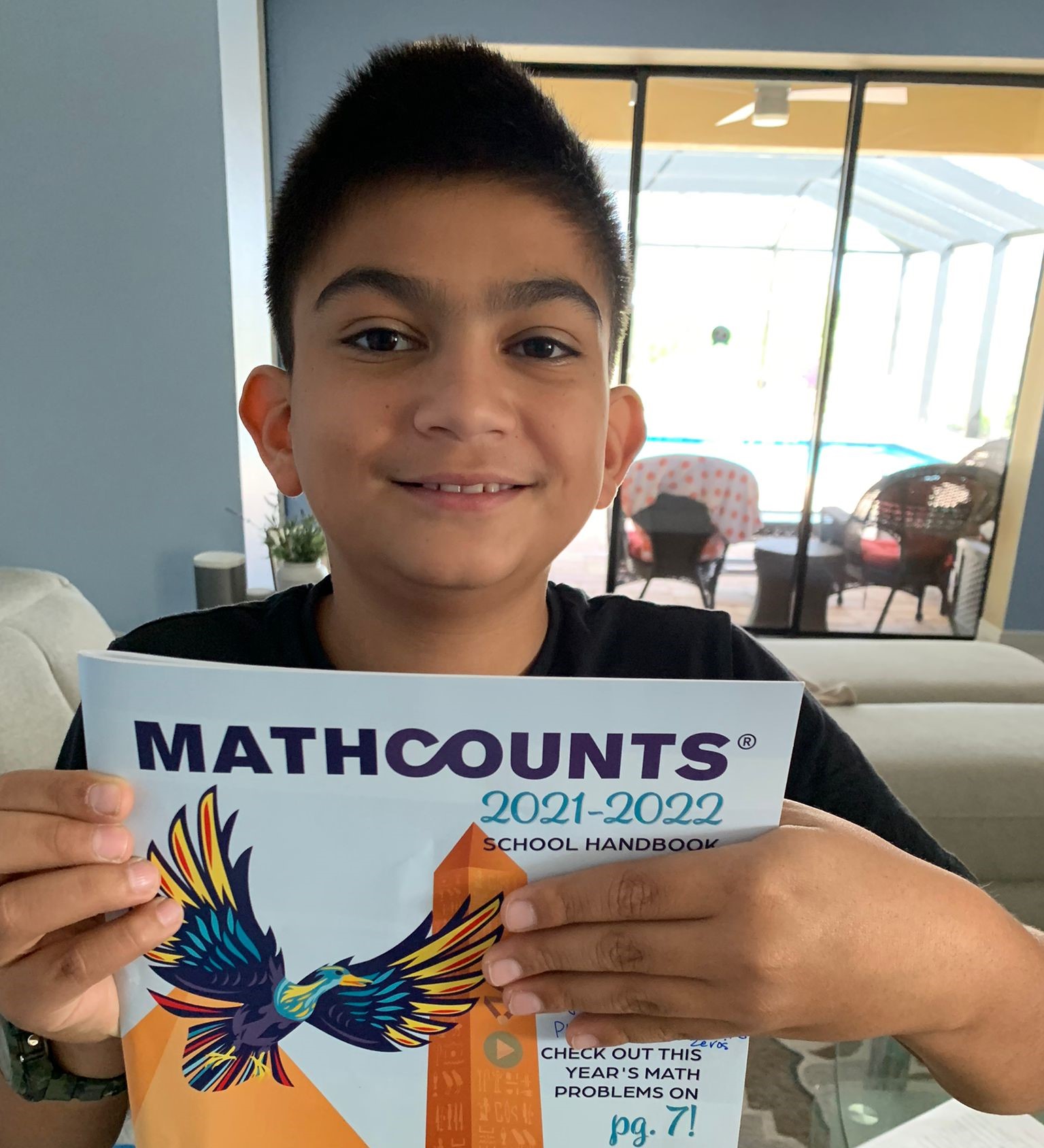 Student holds MATHCOUNTS School Handbook