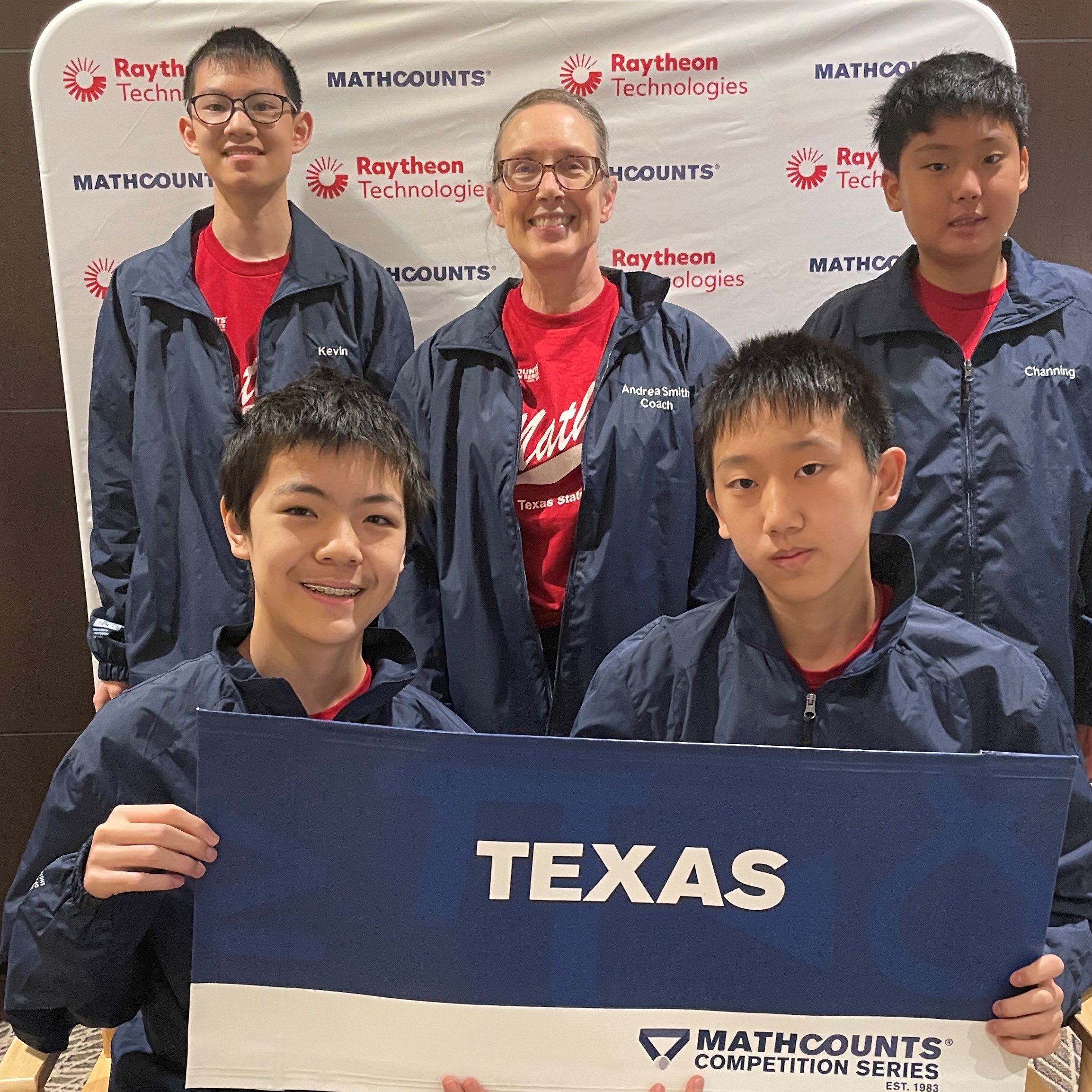 Texas (4 boys and coach) hold up Texas state sign in front of a MATHCOUNTS/Raytheon Technologies backdrop.