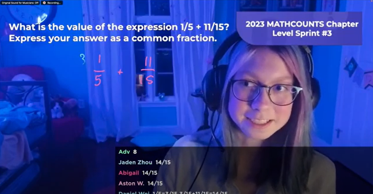 A girl onscreen solves a math problem in a Live Solve while a chat appears on the screen.