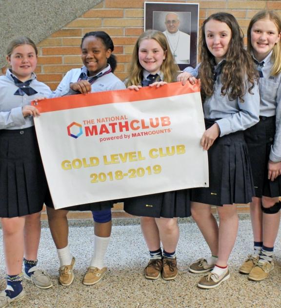 Club holding a Gold Level banner